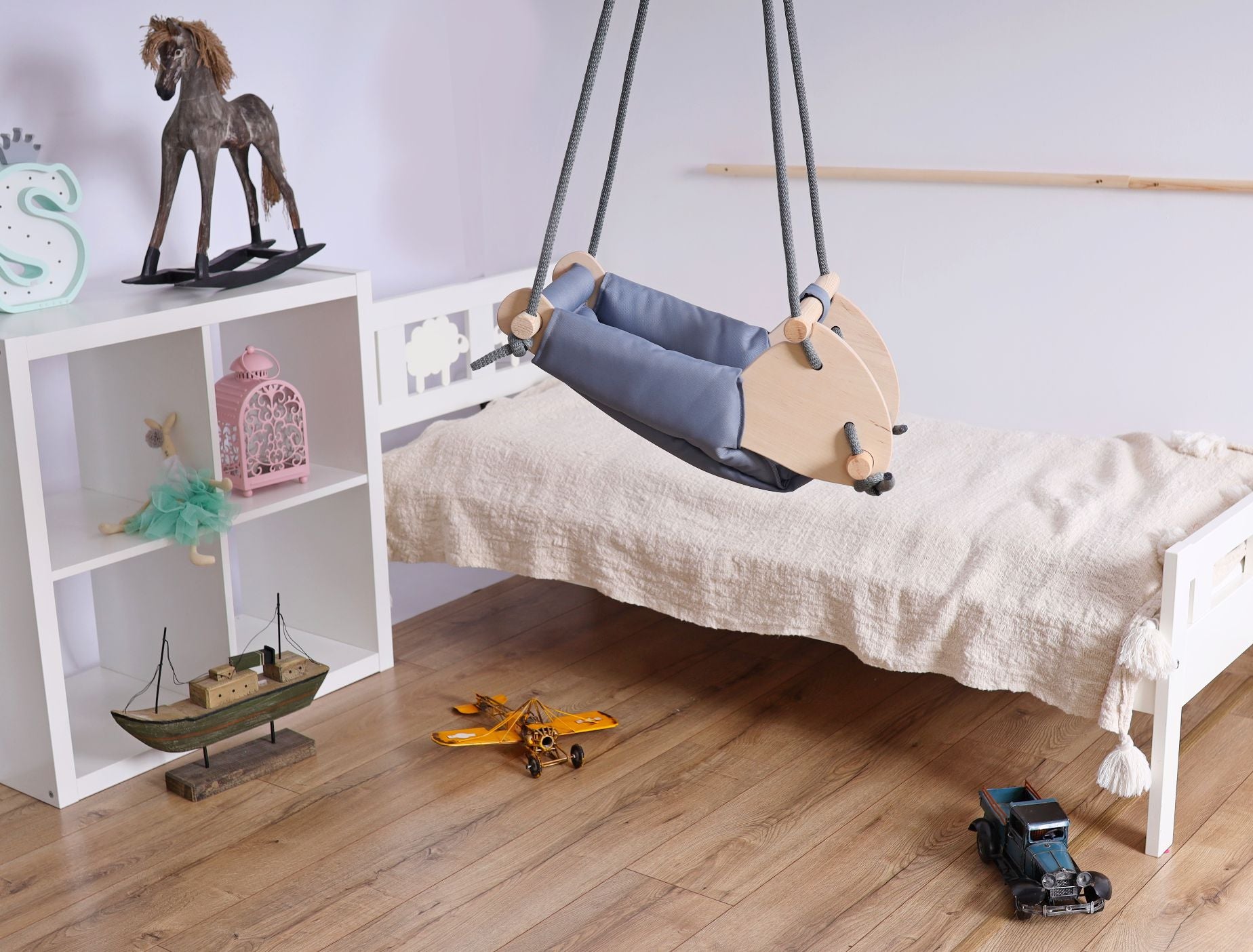 Ochre Ares kids and babies cradle swing with soft fabric and sturdy frame, designed for gentle rocking and comfort.