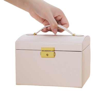 Leather jewelry box by Brown Demeter for organizing earrings and rings, with compartments for secure storage.