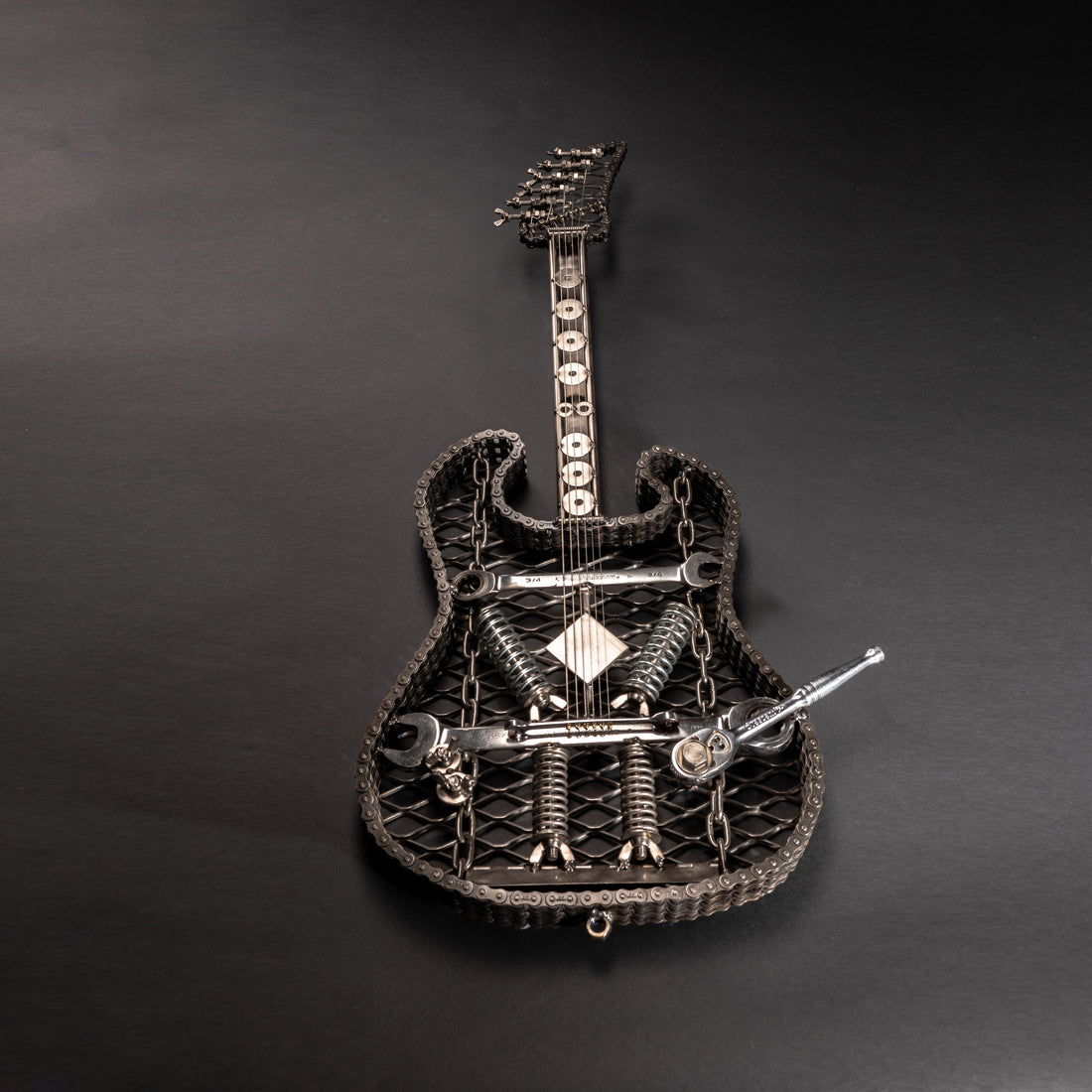 Metal electric guitar sculpture by Turquoise Poppy, heavy metal wall art for home decor, showcasing a detailed guitar design.