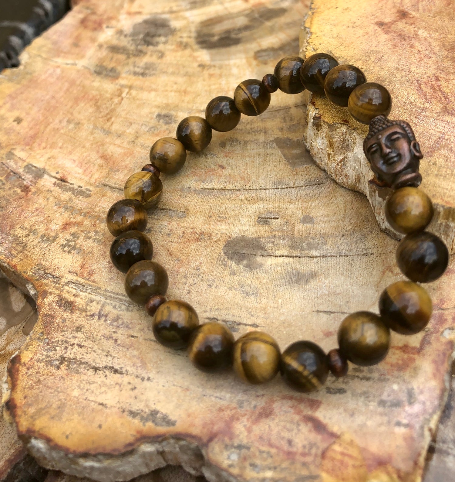 Violet Chaos Tiger Eye and Buddha gemstone bracelet featuring natural polished tiger eye beads and a Buddha charm.