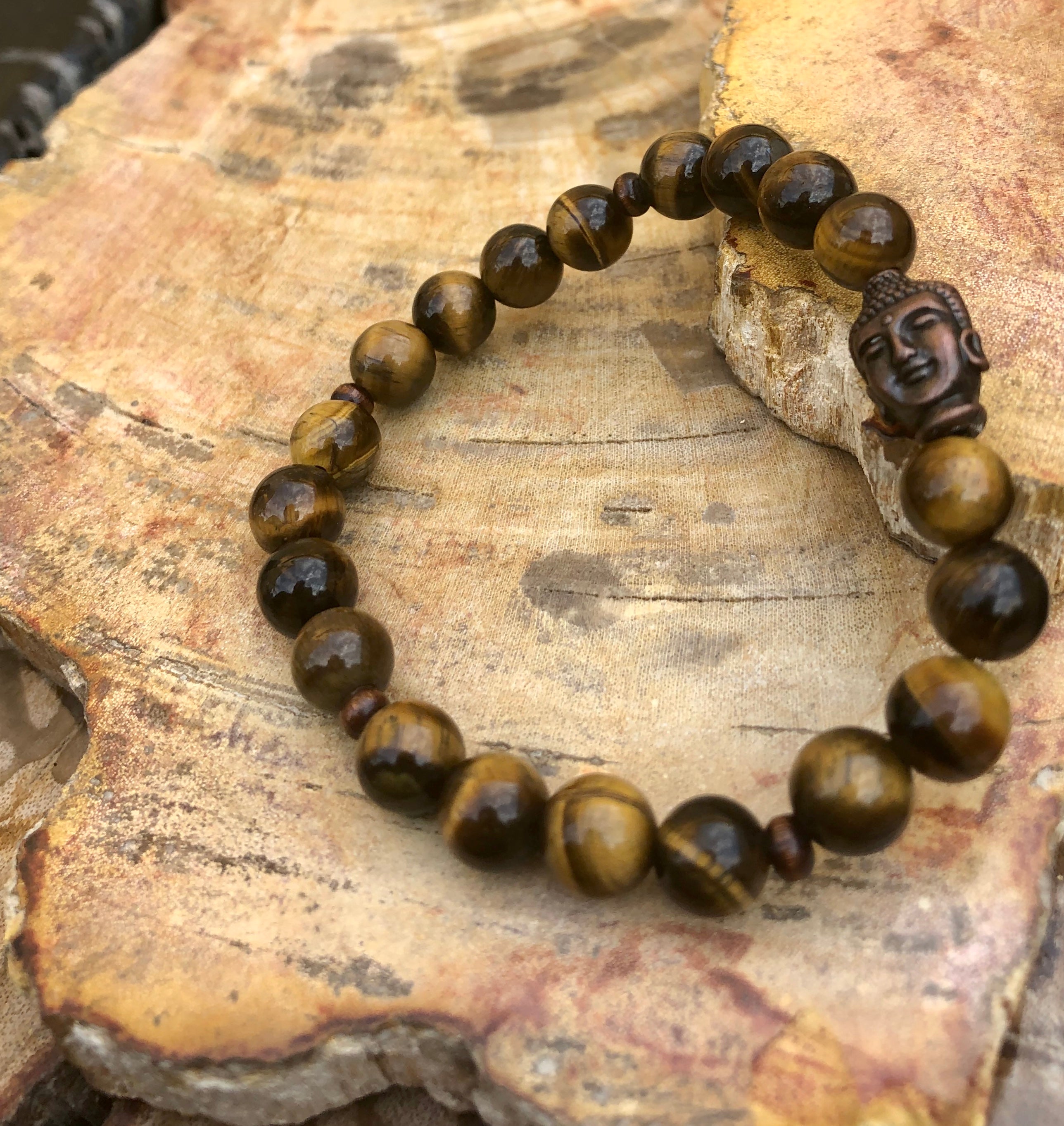 Violet Chaos Tiger Eye and Buddha gemstone bracelet featuring natural polished tiger eye beads and a Buddha charm.