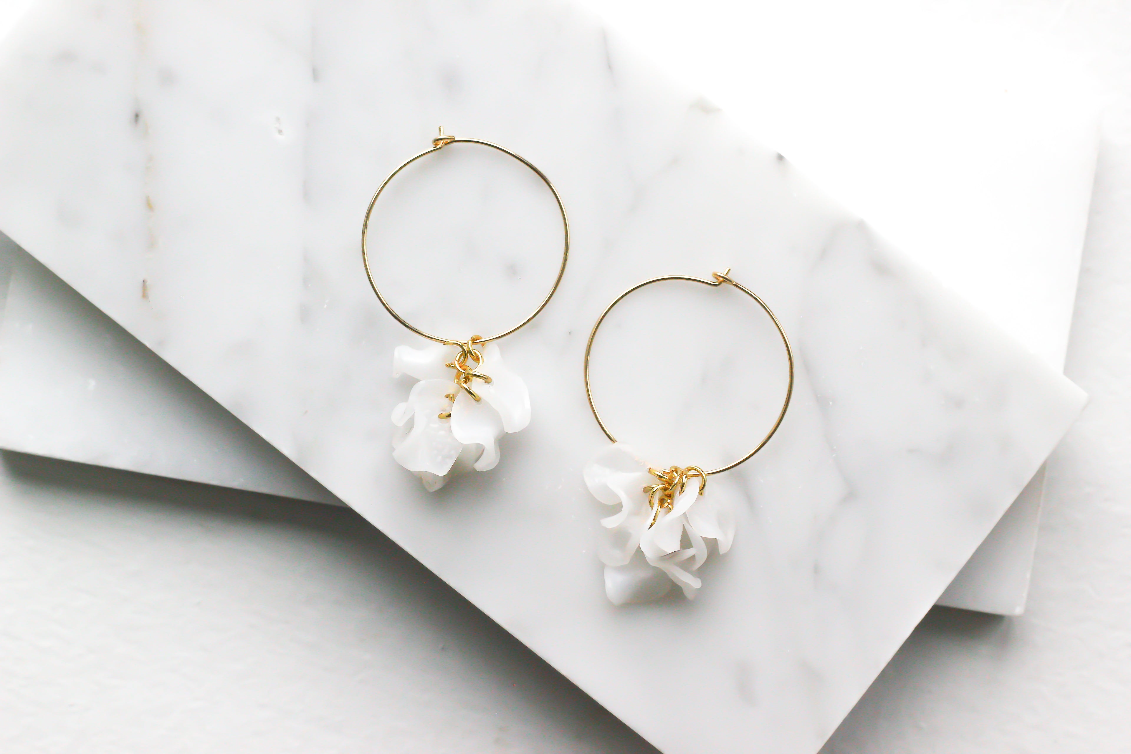 Indigo Jocasta Vita earrings featuring delicate gold hoops with intricate bead details, stylish and elegant jewelry accessory.