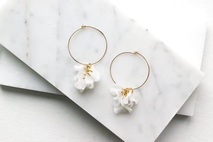 Indigo Jocasta Vita earrings featuring delicate gold hoops with intricate bead details, stylish and elegant jewelry accessory.