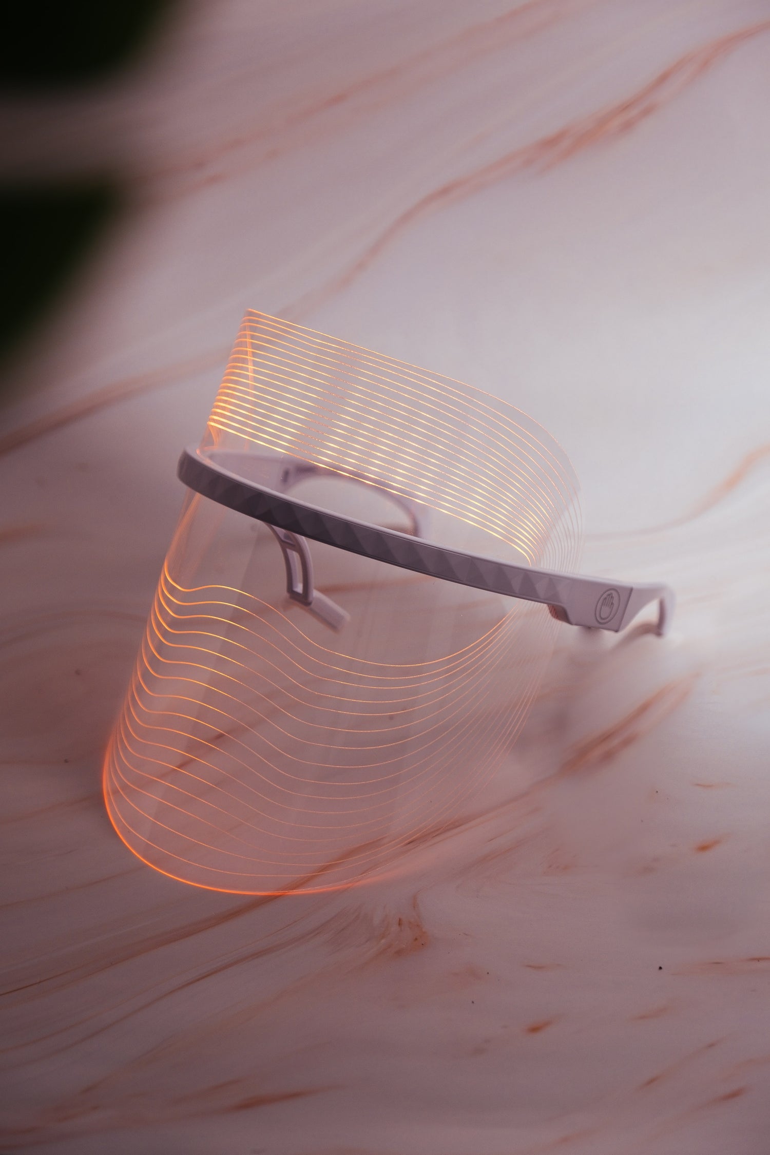 Scarlet Chrysippus Cocoon Skin Enlightenment LED Face Mask with adjustable straps and multiple light therapy panels on a white background.
