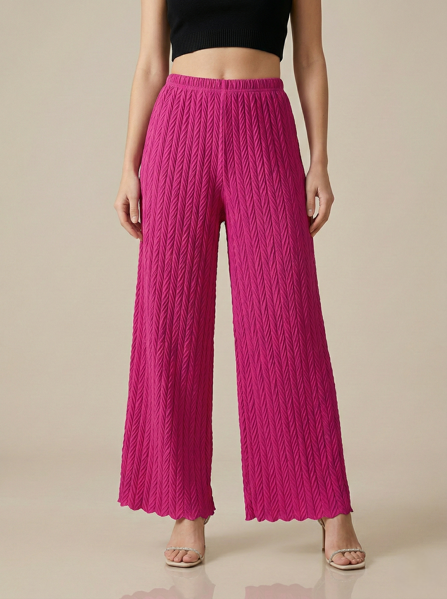 Textured pleated palazzo pants for women by Apricot Dione, shown in a stylish, flowy design suitable for casual or formal wear.