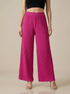 Textured pleated palazzo pants for women by Apricot Dione, shown in a stylish, flowy design suitable for casual or formal wear.