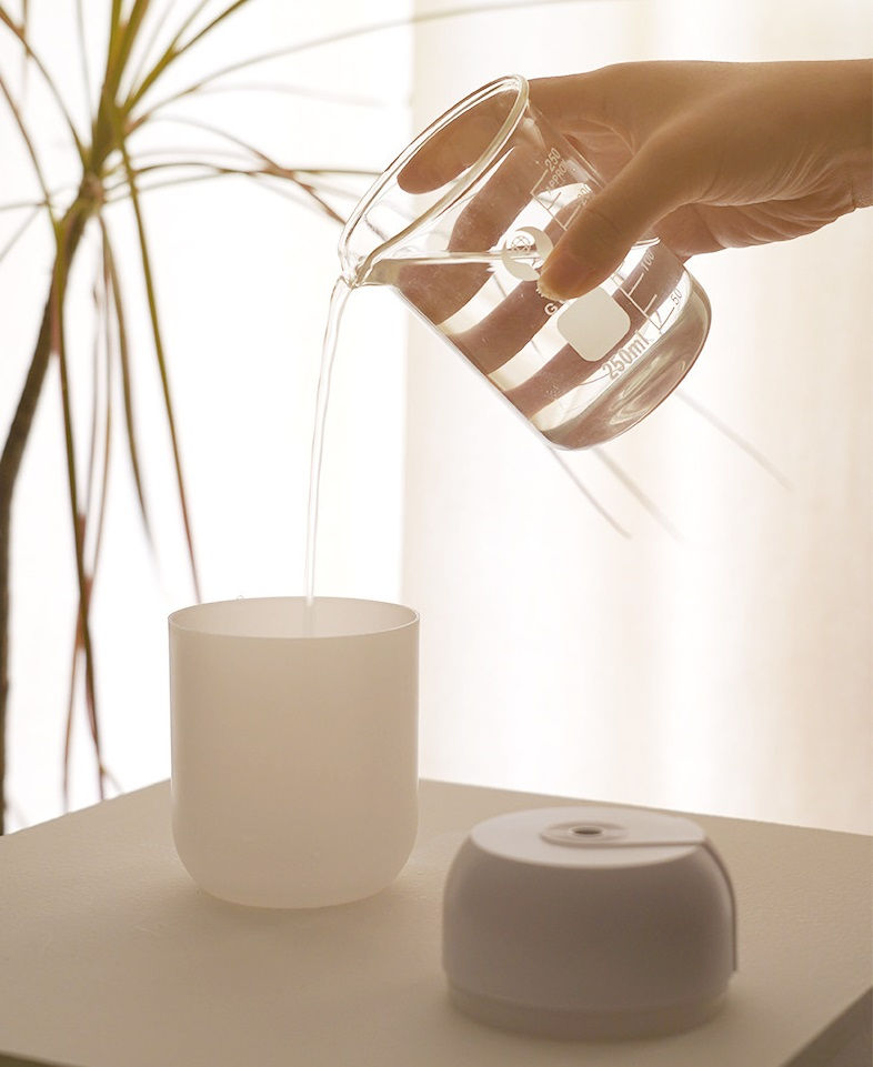 Mini portable ultrasonic air humidifier and aroma diffuser by Lilac Milo, compact tech accessory for essential oil diffusion.
