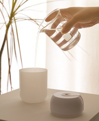Mini portable ultrasonic air humidifier and aroma diffuser by Lilac Milo, compact tech accessory for essential oil diffusion.