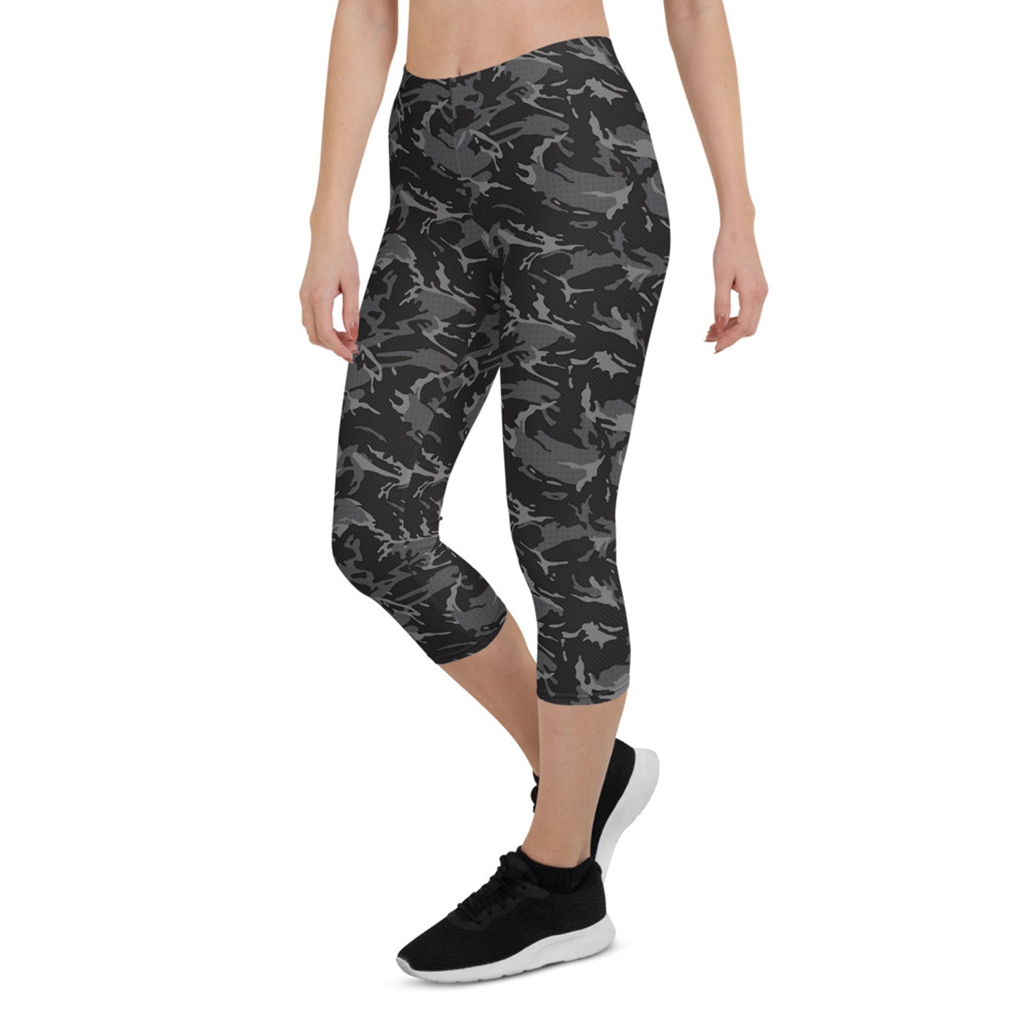 Women’s black camo Capri leggings by Harlequin Icarus, shown on a model, highlighting the fitted style and camouflage pattern.