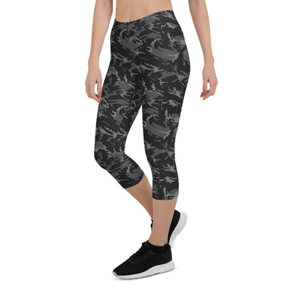 Women’s black camo Capri leggings by Harlequin Icarus, shown on a model, highlighting the fitted style and camouflage pattern.