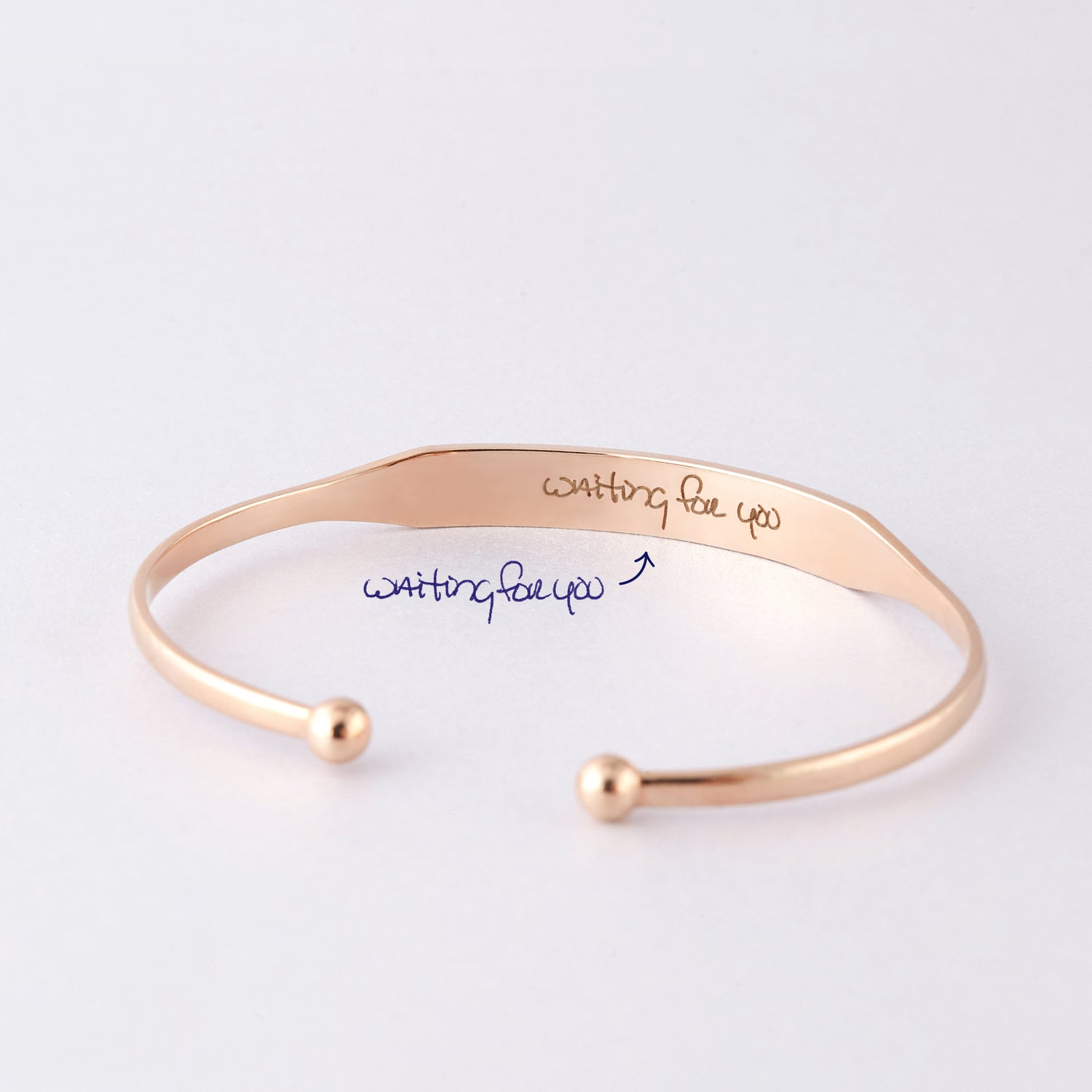 Green Millie handwritten cuff bracelet cufflinks with elegant script design on shiny metal surface