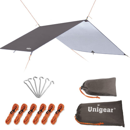 Indigo Eurybia rainproof camping tarp shelter set up outdoors, showcasing durable weather-resistant outdoor gear for camping.