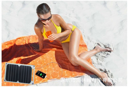 Teal Simba solar power pad with suction cups attached to a solar panel, used as a tech accessory for renewable energy.