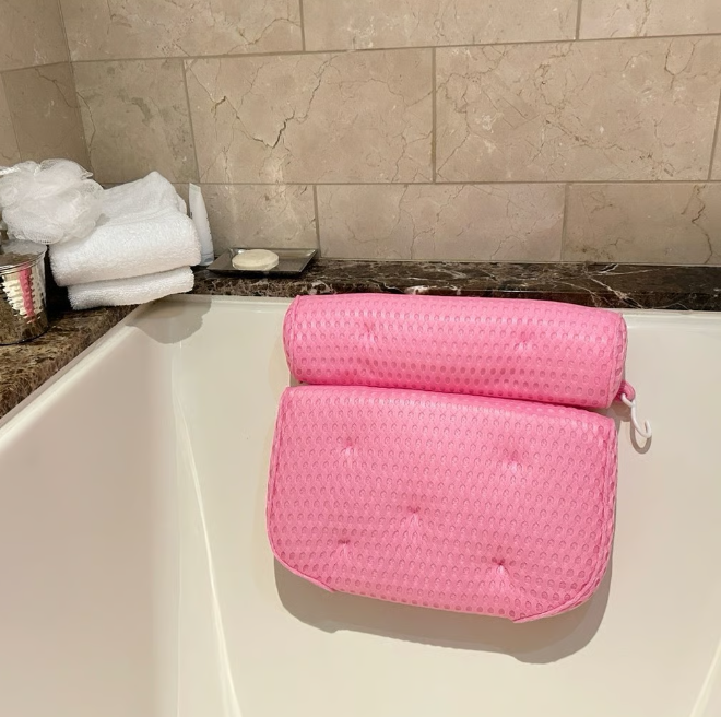 Pink bathtub pillow with anti-slip suction cups and 4D mesh for comfortable bodycare in the bath by Plum Charlie.