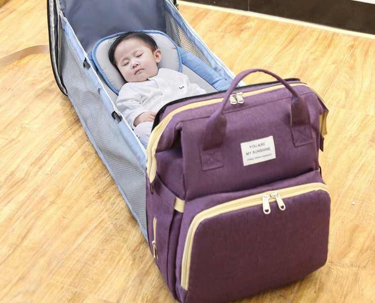 Carmine Juneberry ALLFASHION™ FoldAway BabyNest Backpack in black with adjustable straps and compact foldable design.