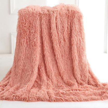 Yellow Pandora Ultra Soft Faux Fur Throw Blanket draped over a cozy armchair in a home setting.
