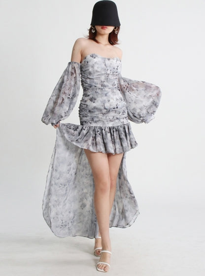 Mauve Ananke asymmetrical mini dress with slash neckline and puff sleeves, solid minimalist design, worn by a model.