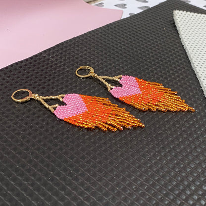 Yellow Athena LOVE earrings with pink and orange ombre fringe, featuring colorful, dangling earring design.