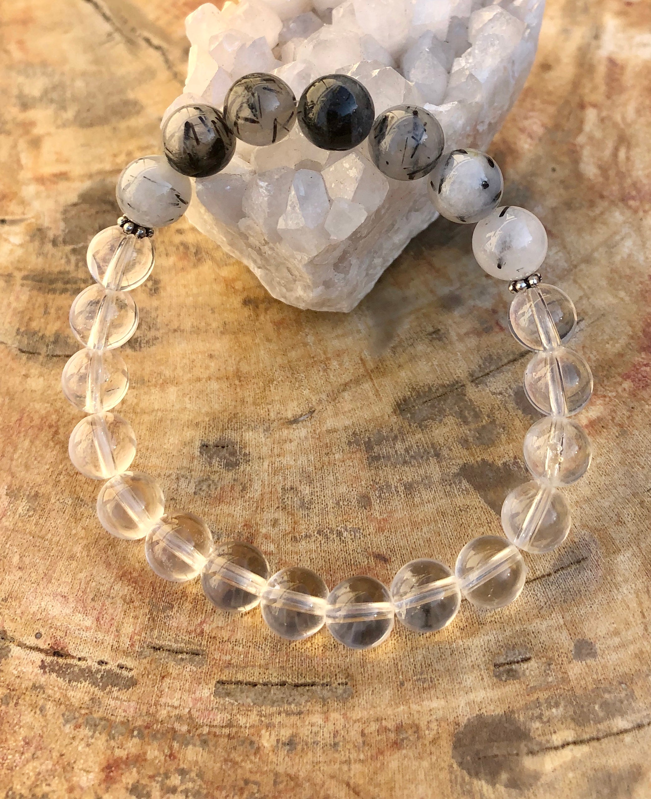 Black Tourmaline and Crystal Quartz stretch bracelet with genuine crystals, featuring black and clear gemstone beads on a flexible band.