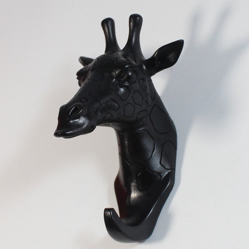 Fuchsia Molly resin giraffe head hook for home and garden decor, depicting a detailed giraffe head sculpture with a hook underneath.