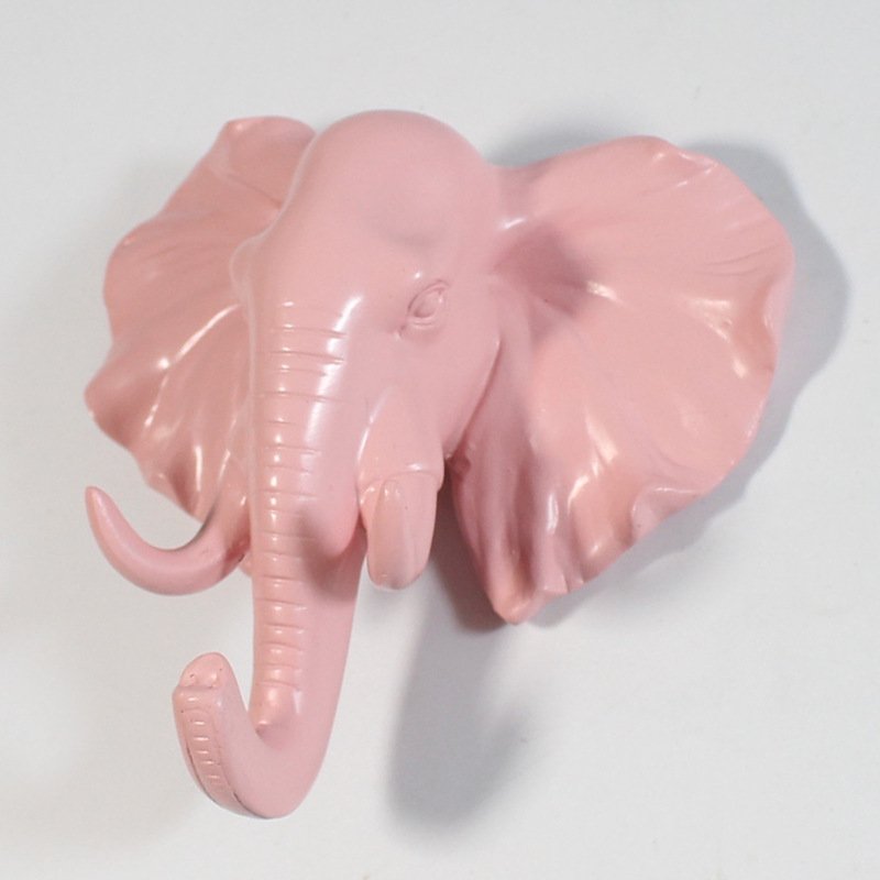 Fuchsia Molly resin elephant head hook mounted on a wall, decorative home &amp; garden accessory with detailed elephant design.