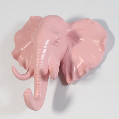Fuchsia Molly resin elephant head hook mounted on a wall, decorative home &amp; garden accessory with detailed elephant design.
