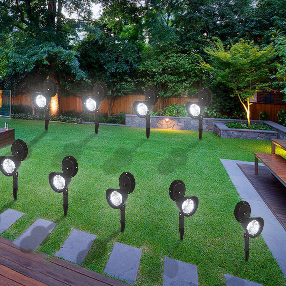 Two Lilac Milo solar landscape LED spotlights illuminating a garden pathway at dusk, showcasing outdoor garden lighting.