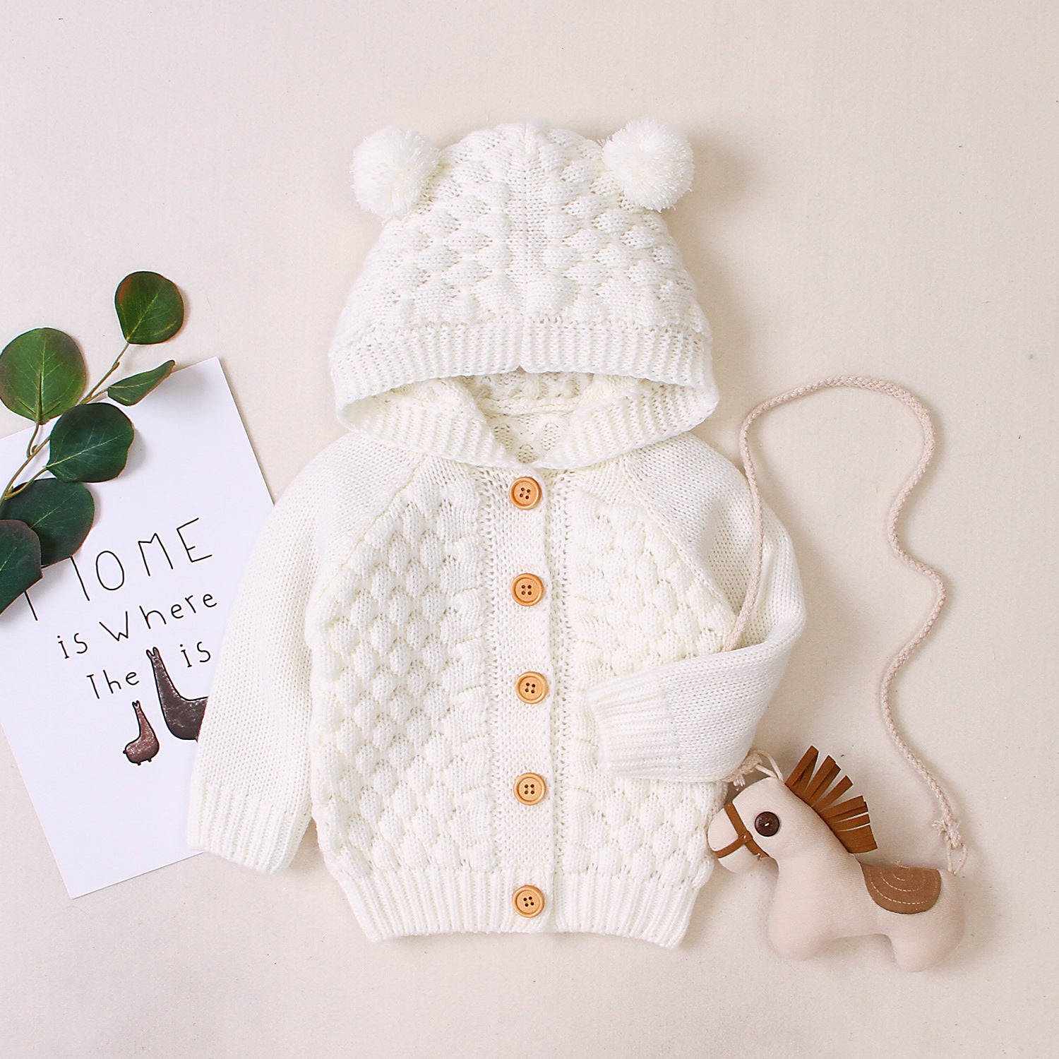 Carmine Juneberry KuschelGlöckchen™ baby hooded knit jacket with pom-pom, soft, cozy baby clothing in pastel colors.
