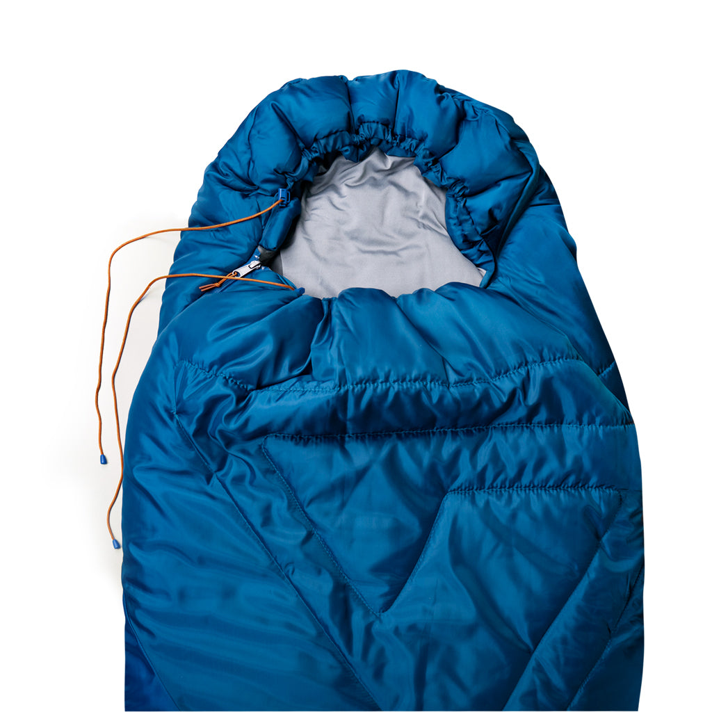 Indigo Eurybia Camfy 30 sleeping bag for camping, shown rolled up with adjustable straps and durable fabric for outdoor sleeping.