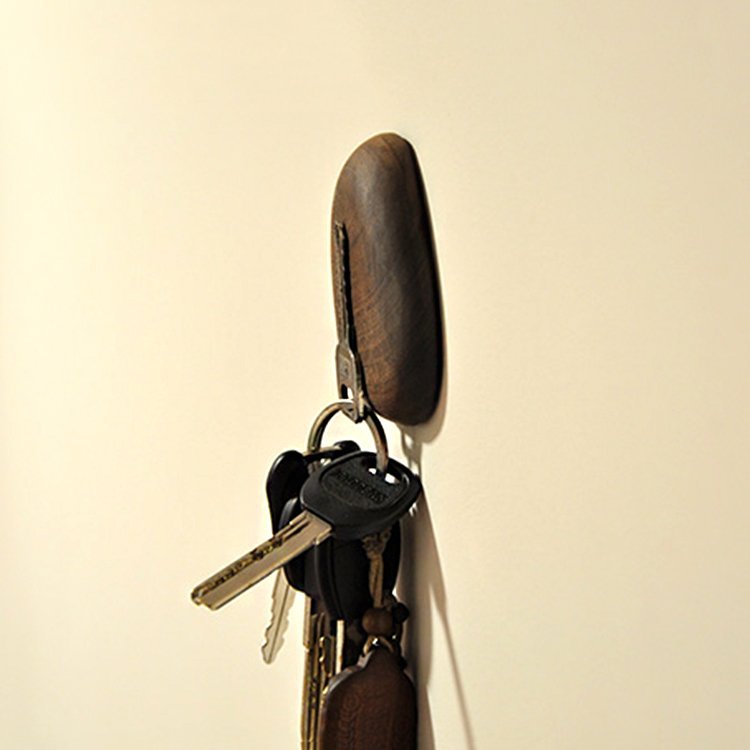 Walnut magnet key holder from Fuchsia Molly, mounted on wall with hooks for organizing keys in a home and garden setting.