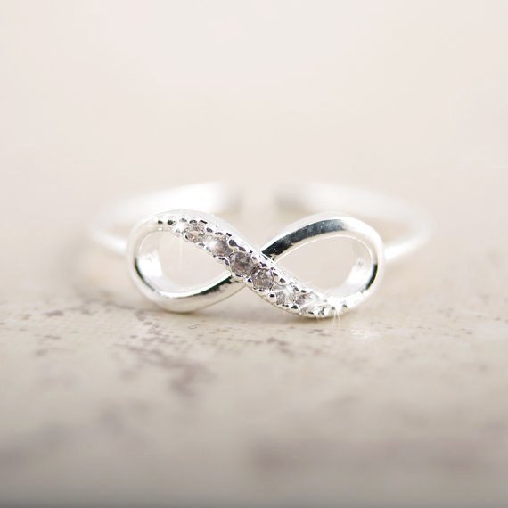 Silver infinity ring with rhinestones by Fuchsia Molly, showcasing a sparkling, elegant design in a close-up shot.