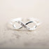 Silver infinity ring with rhinestones by Fuchsia Molly, showcasing a sparkling, elegant design in a close-up shot.