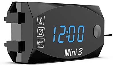 Teal Simba 3-in-1 automotive voltmeter, clock, and thermometer display showing digital readouts on a car or motorcycle dashboard