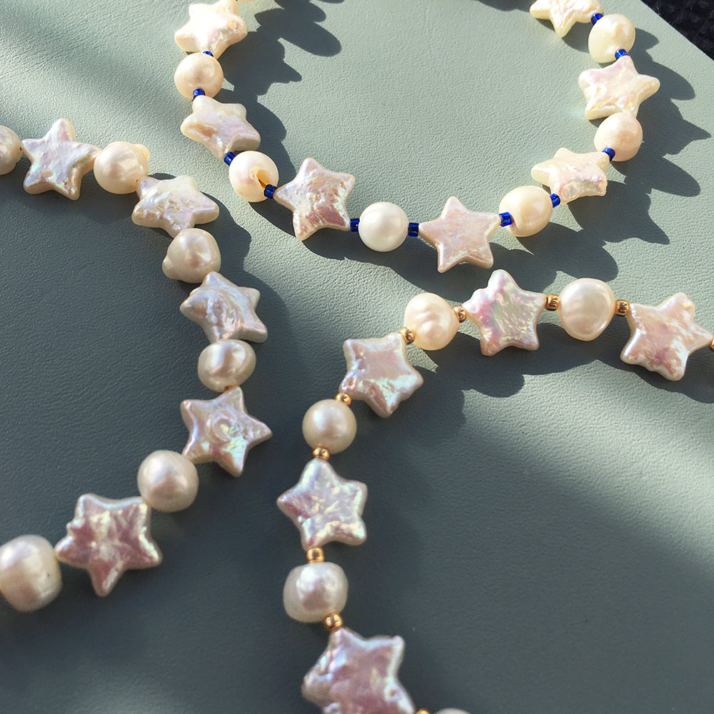 Yellow Athena Pearl Stars bracelet featuring white pearls and star-shaped charms on a delicate bracelet chain.