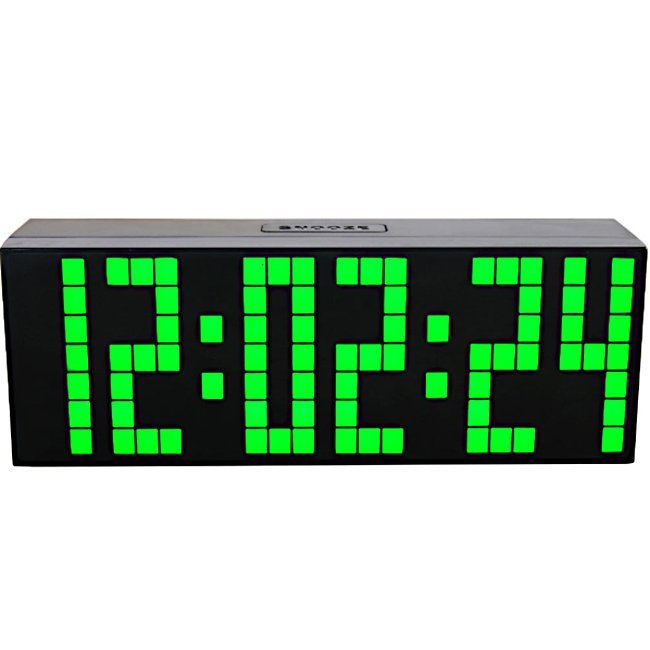 Fuchsia Molly home LED digital clock displaying time on a sleek black surface in a home setting