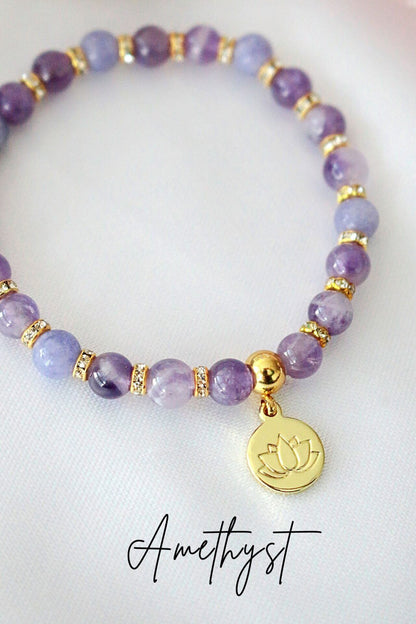 Ultramarine Birch rose quartz and amethyst elastic bracelet with a 24K lotus flower charm, featuring polished gemstone beads.