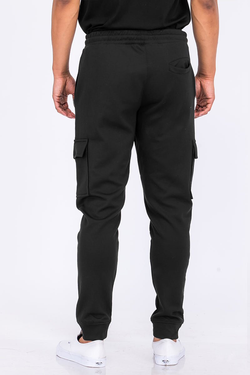 Lime Milo cotton blend cargo joggers pants with multiple pockets and relaxed fit, shown in a casual outdoor setting.