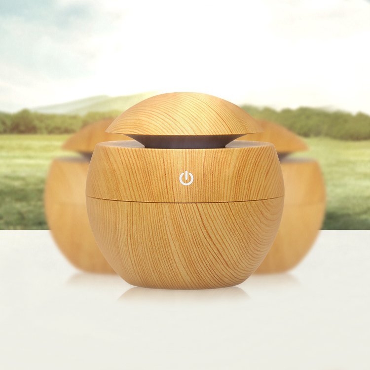 Fuchsia Molly wood grain desktop humidifier on a home table, blending natural wood finish with modern home and garden decor.