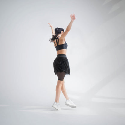 Indigo Thalassa MINI PLESSY MESH SKIRT showing a lightweight, black mesh skirt with pleated design and elastic waistband.