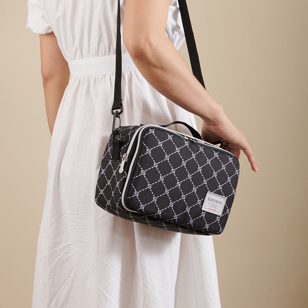 Maroon Chronos all-in-one diaper bag with changing pad, featuring multiple compartments and comfortable straps for parents.