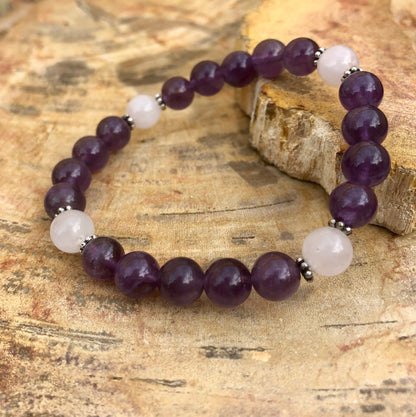 Violet Chaos Amethyst and Rose Quartz stretch bracelet with natural crystal beads, showcasing vibrant purple and soft pink stones.