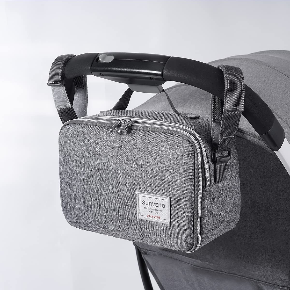 Maroon Chronos all-in-one diaper bag with changing pad, featuring multiple compartments and a sleek design for parents.