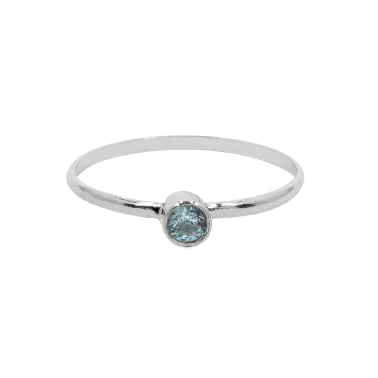 Sterling silver ring with dainty blue topaz solitaire gemstone, elegant jewelry piece by Grey Clymene.
