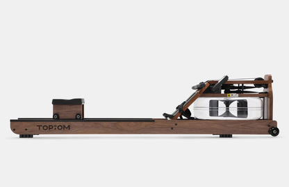 Olive Nyx Topiom rowing machine for home use with solid wood frame and TM3 monitor, shown with adjustable foot straps and sleek design.
