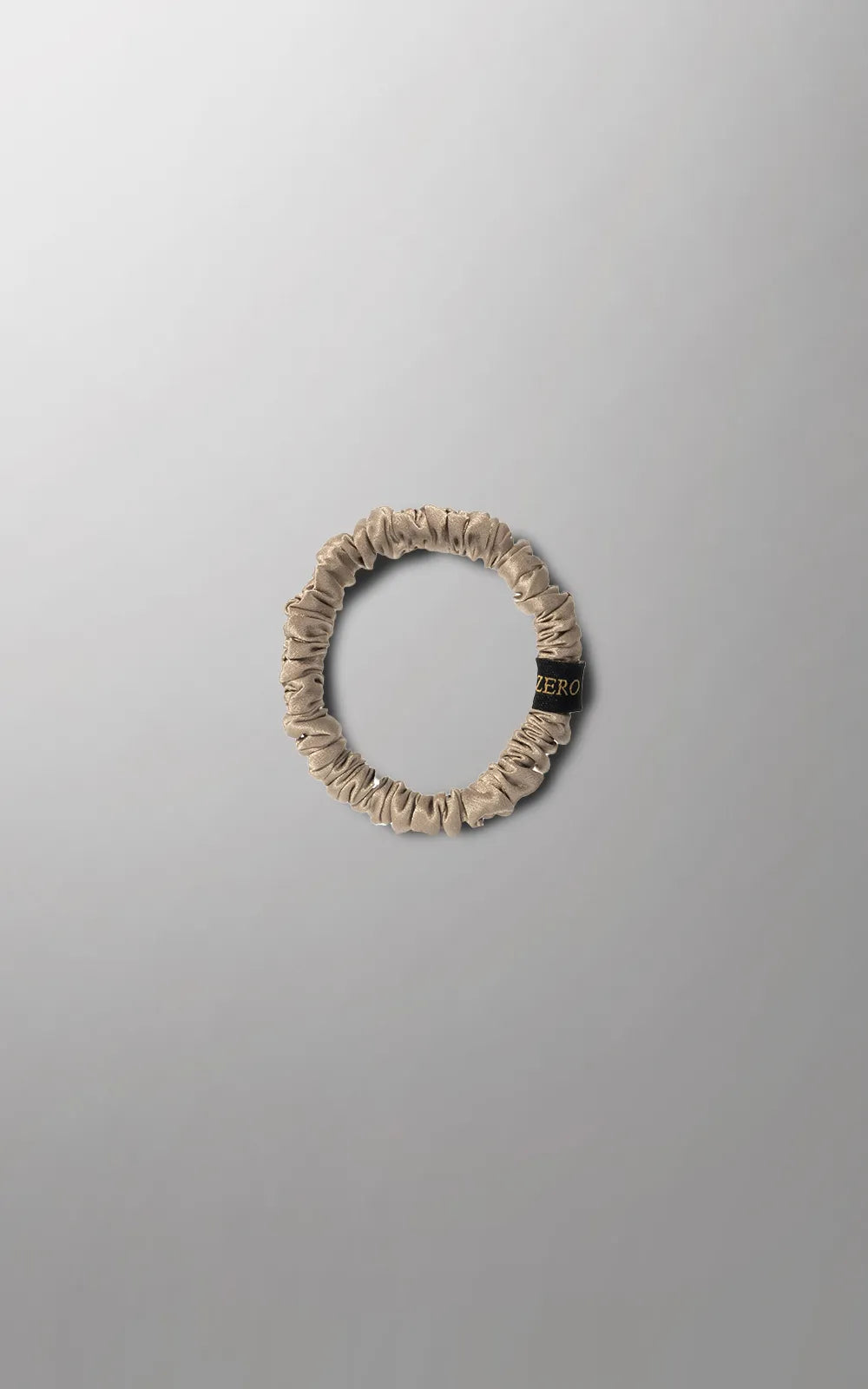 Silk hair ties in gray, golden, and white from Burgundy Clover, available in medium and large sizes, shown in close-up.