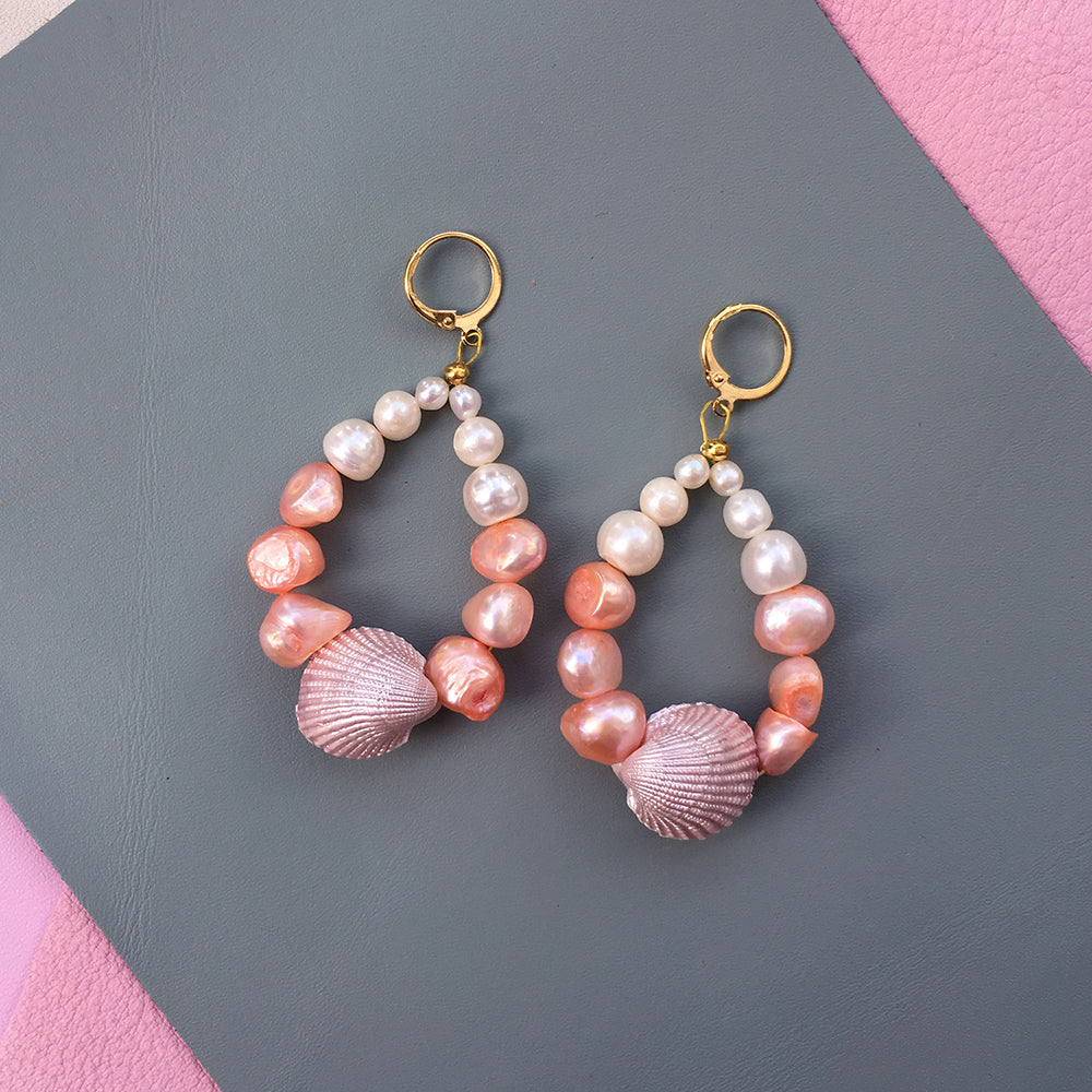 Yellow Athena Candy Shell Pearl Earrings featuring round pearl dangles on gold hooks, stylish and elegant jewelry accessory.