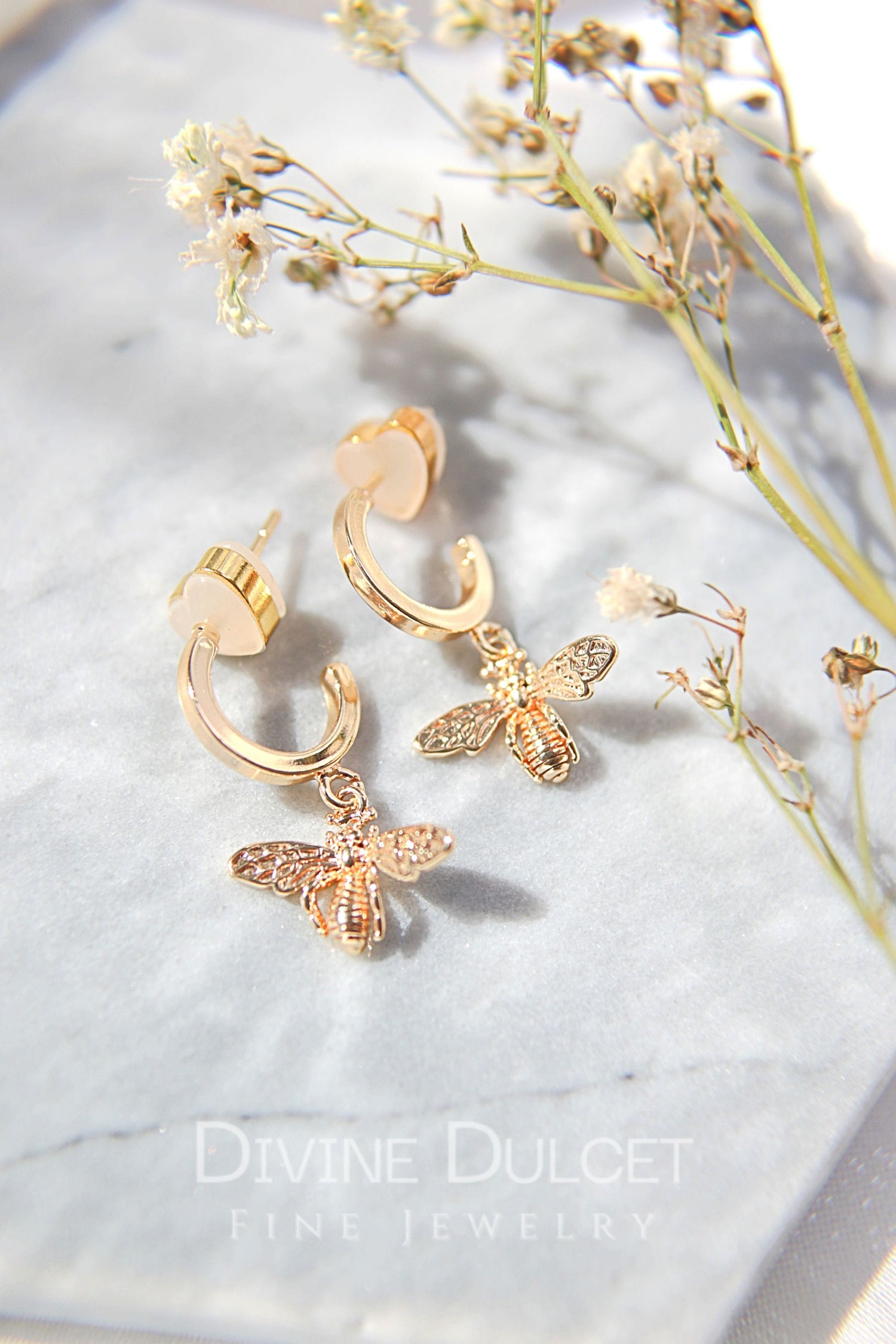 24 Karats Gold Bee Hoop Earrings by Ultramarine Birch featuring detailed bee charms on gold hoop earrings.
