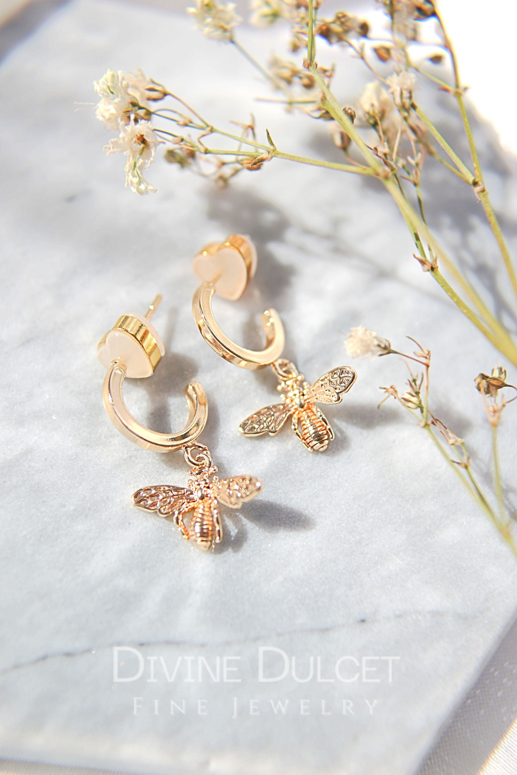 24 Karats Gold Bee Hoop Earrings by Ultramarine Birch featuring detailed bee charms on gold hoop earrings.