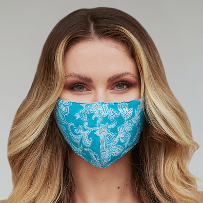 Turquoise paisley floral face mask for women from Cyan Poppy, featuring vibrant paisley and floral patterns on fabric.