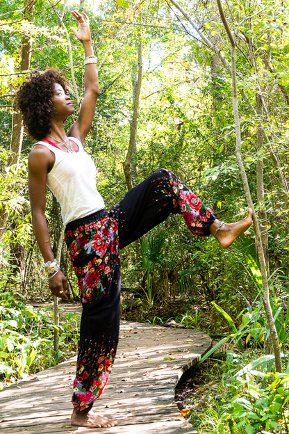 Black floral boho pants by Tan Smokey featuring a relaxed fit, hippie style, perfect for yoga or casual wear.